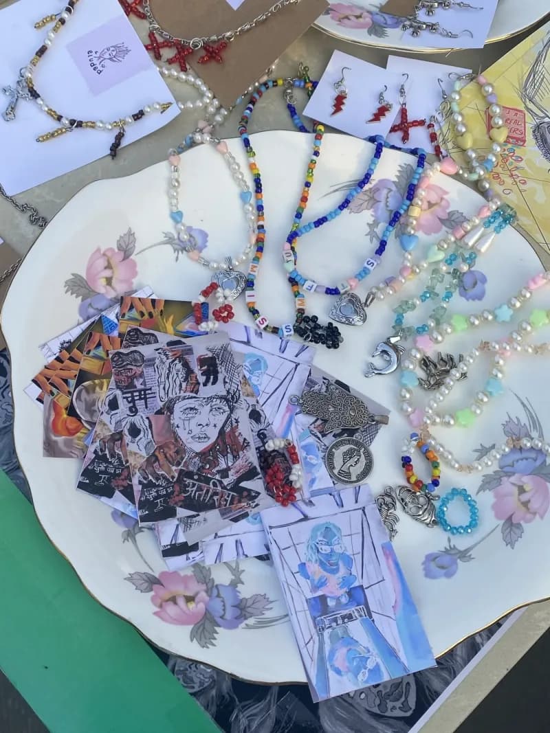 A tray of handmade beaded jewellery, charms and art prints from one of the stallholders.
